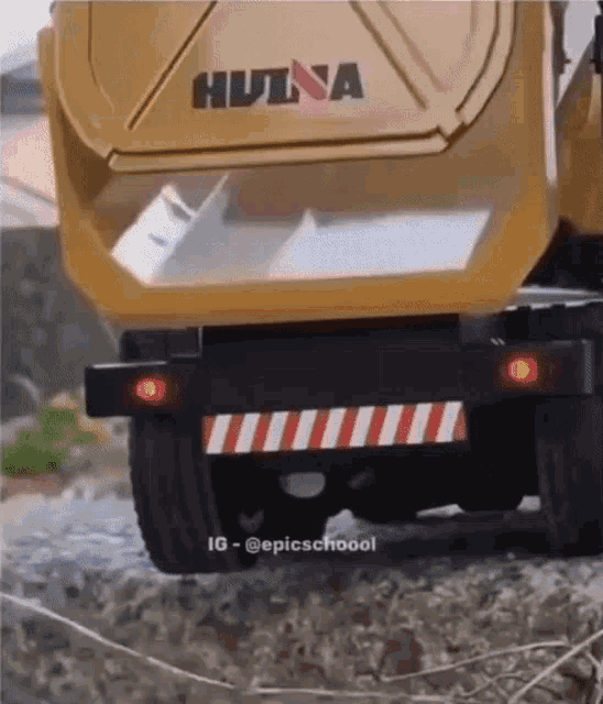 a hulna dump truck is driving down the road