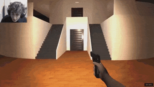 a person is holding a gun in front of a door