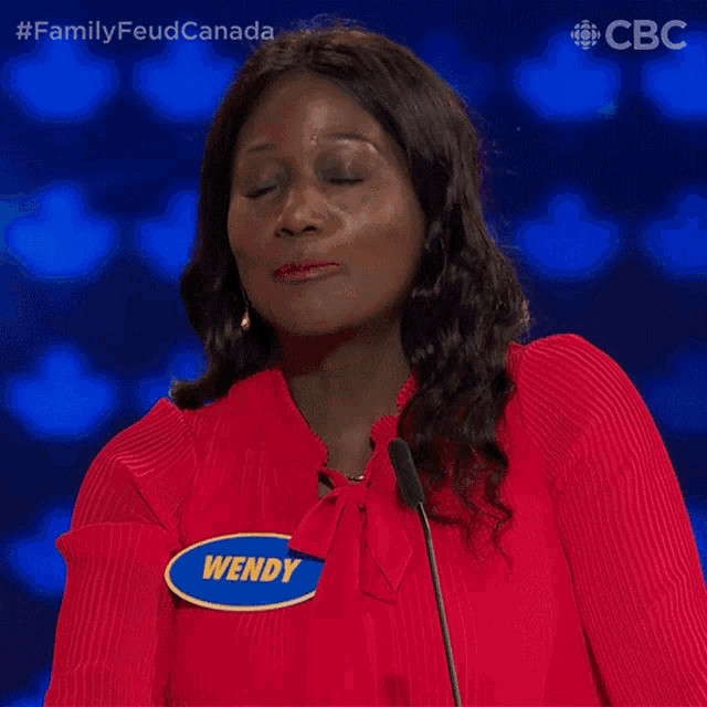 a woman wearing a red shirt with a name tag that says wendy