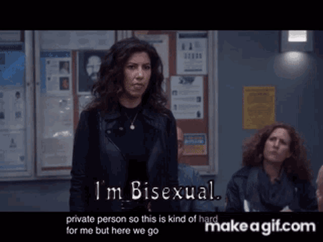a woman says that she is bisexual in front of a bulletin board