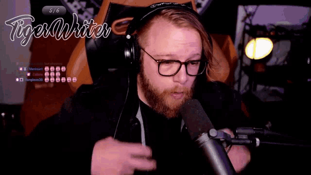 a man wearing glasses and headphones is talking into a microphone with the words tiger writer behind him