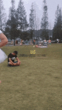 a group of people are playing in a grassy field with the words squad star singer on the bottom