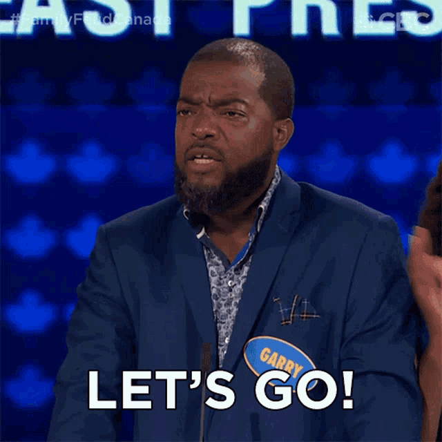 a man in a suit says let 's go on a stage
