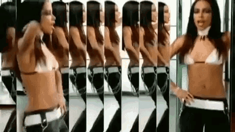 a woman in a bikini is dancing in a mirror .