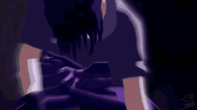 a close up of a person 's face with purple smoke coming out of it in a dark room .