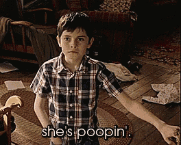 a young boy in a plaid shirt says she 's poopin in a living room