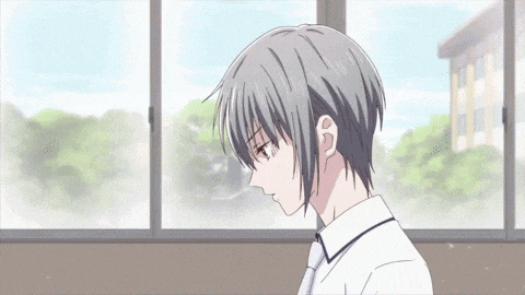 a man with gray hair is sitting in front of a window .