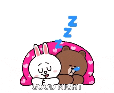 a couple of cartoon characters are laying on top of each other on a pink blanket .