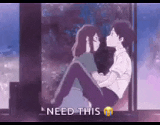 a boy and a girl are sitting next to each other and kissing .