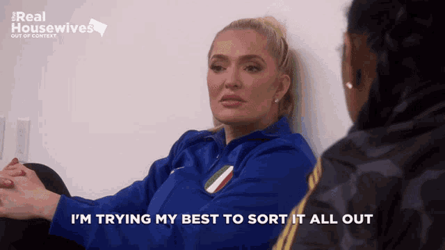 a woman says i 'm trying my best to sort it all out in front of a real housewives logo