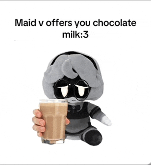 a stuffed animal holding a cup of chocolate milk