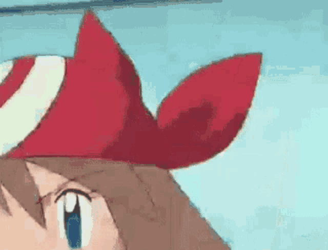 a close up of a cartoon character wearing a red hat and a red bow .