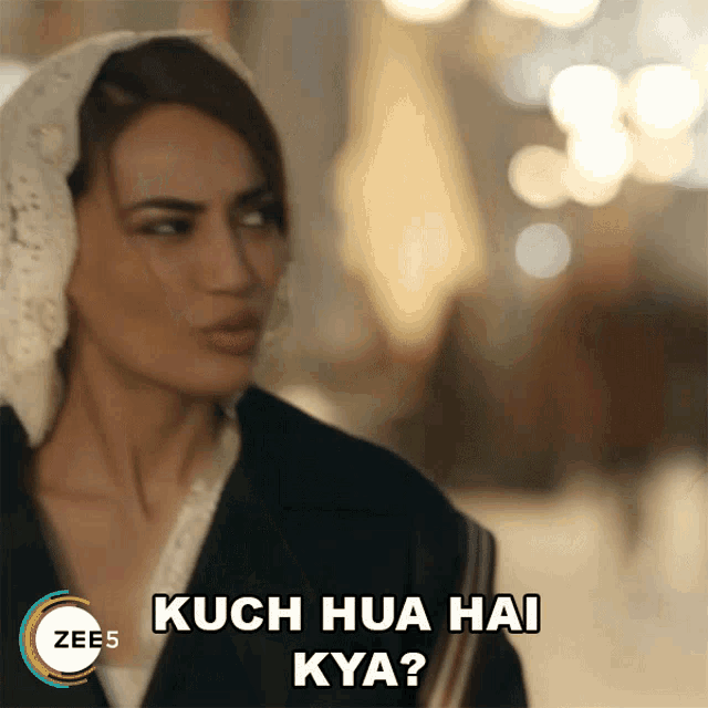 a woman wearing a head scarf says kuch hua hai kya ?