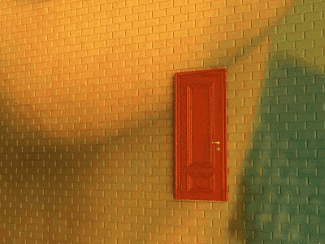 a brick wall with a red door in the middle