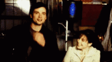 a man is covering his mouth while a woman looks on