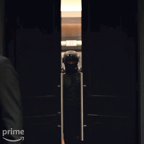 a group of police officers are walking through a doorway with the word prime on the bottom