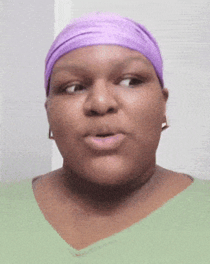 a woman wearing a green shirt and a purple headband