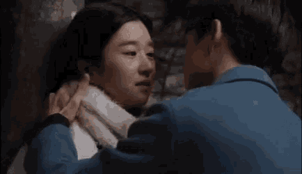 a man and a woman are kissing each other in a dark room .