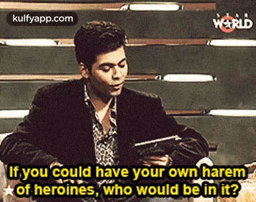 a man is sitting at a table holding a tablet and talking about heroines .