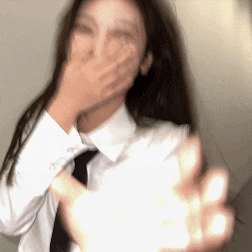 a blurry picture of a woman in a white shirt and black tie