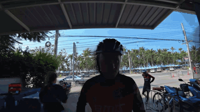 a man wearing a helmet and a shirt that says ' tcl ' on it
