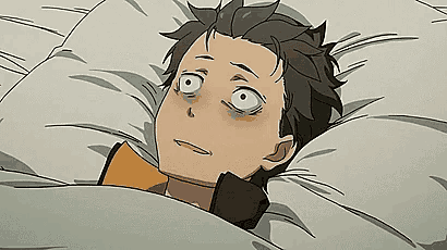 a man is laying in a bed with a pillow on his head and looking at the camera .