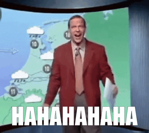 a man in a suit and tie is laughing in front of a screen that says '  hahaha '