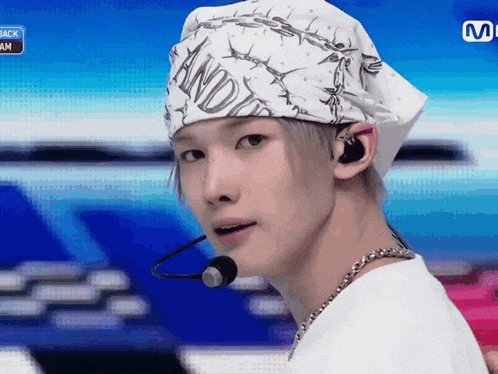 a young man wearing a bandana with barbed wire on it