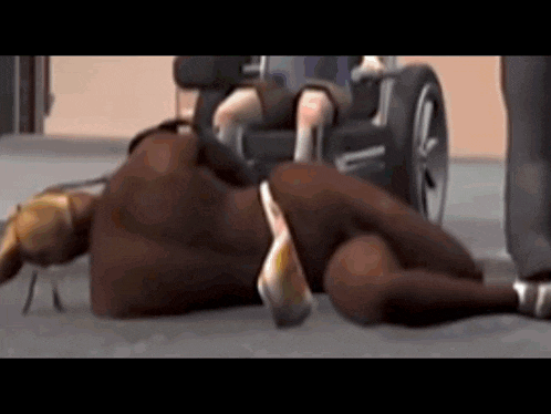 a man in a wheelchair is laying on the ground next to a woman in a bikini
