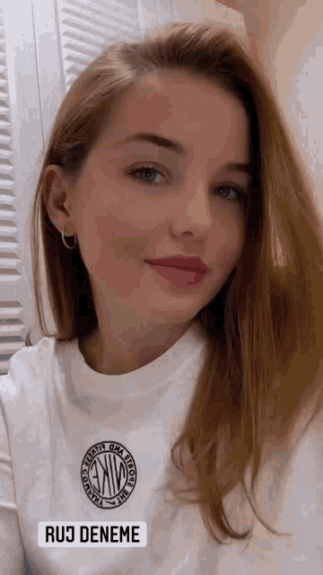 a woman wearing a white t-shirt with a nike logo on it