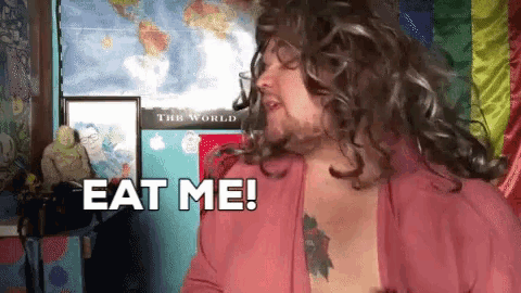 a man with a tattoo on his chest is saying eat me