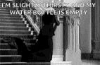 a black and white photo of a woman standing on a set of stairs with a water bottle .