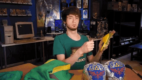 a man wearing a green shirt that says " albooks " holds a book