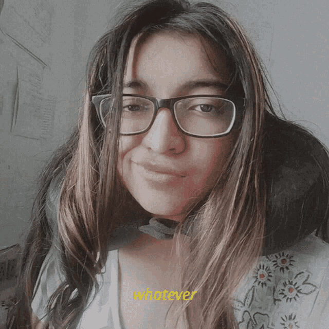 a girl wearing glasses and a white shirt says whatever on the bottom right