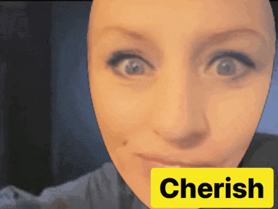 a close up of a woman 's face with a yellow sign that says cherish