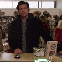 a man standing behind a counter with a sign that says countdown on it