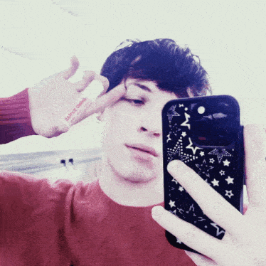 a person taking a selfie with a phone and a lip balm that says bape on it