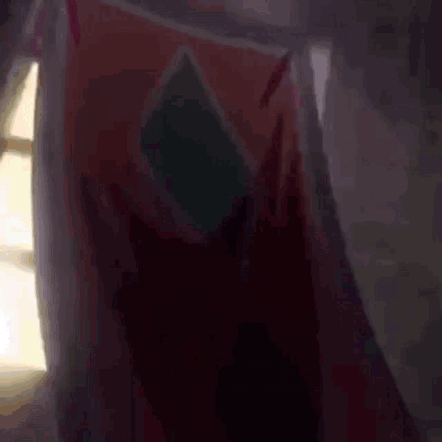 a blurred image of a person 's feet with a purple shoe in the background