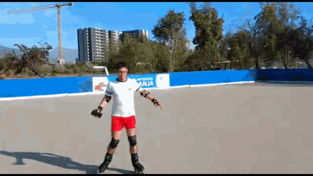 a man rollerblading in front of a wall that says anja on it