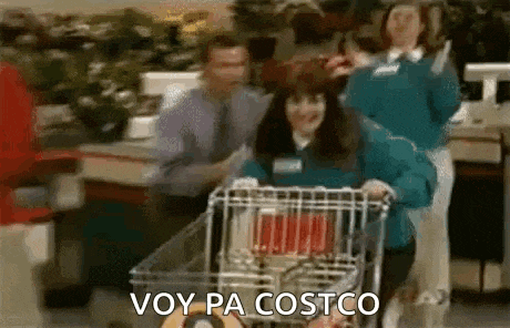 a woman is pushing a shopping cart in a grocery store and says `` voy pa costco '' .
