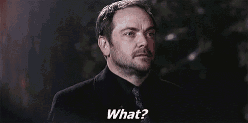 a man with a beard is making a funny face and saying `` what ? ''