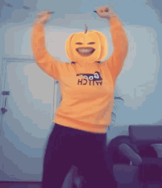a person with a pumpkin on their head wearing a sweater that says alich