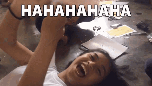 a girl is laying on the floor and laughing with the words hahahaha written above her