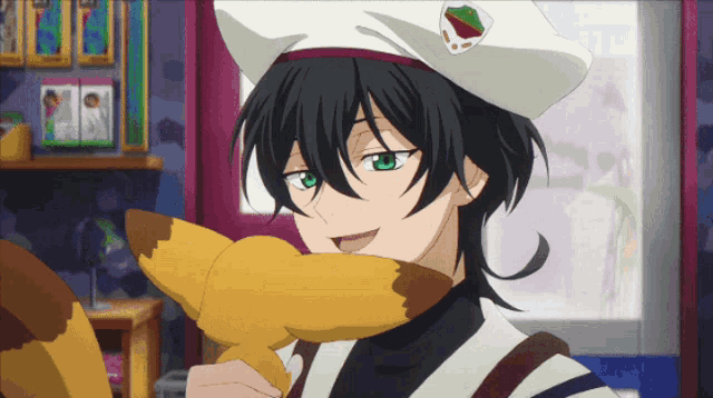 a boy with green eyes and a white hat is holding a stuffed animal in front of his face