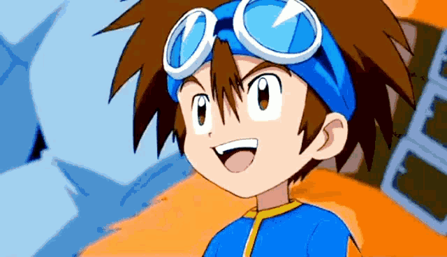 a boy wearing a blue shirt and goggles is smiling