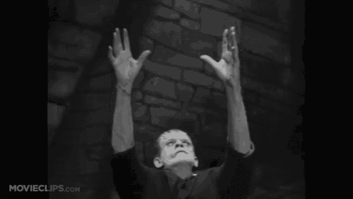 a black and white photo of frankenstein with his arms in the air
