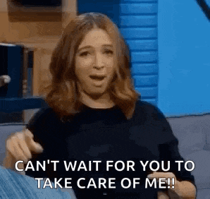 a woman is sitting on a couch with her mouth open and pointing at the camera .