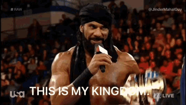 a man with a beard is holding a microphone and saying this is my kingdom