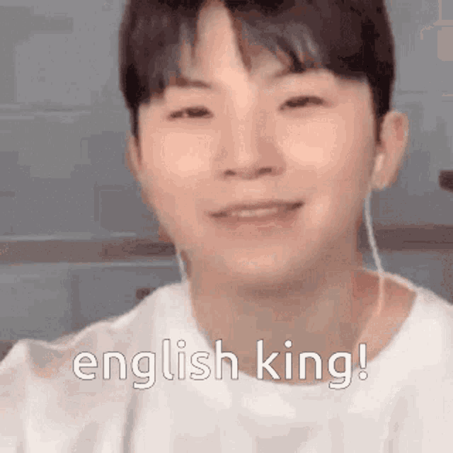 a young man wearing headphones is smiling and says english king