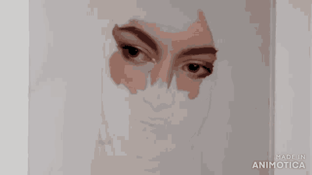 a close up of a person painting a woman 's face with a brush .